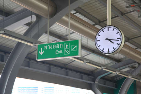 Clock and exit sign on the train stationの写真素材