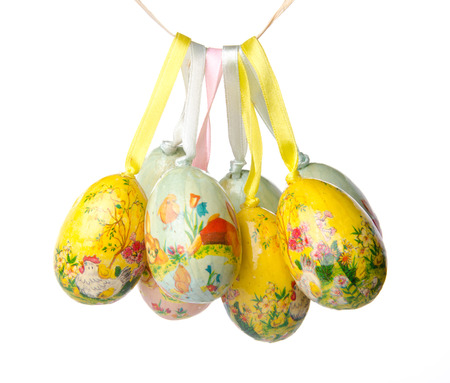Easter eggs hanging, isolated on whiteの写真素材