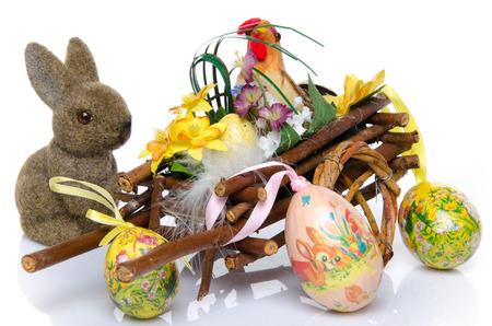 Cock in a cart with easter eggs and a bunny, isolated on whiteの写真素材