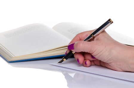 Woman's hand writing on paper, isolated on whiteの写真素材