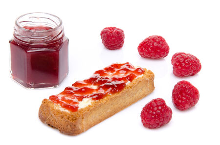 Raspberries, jam and a toast, isolated on whiteの写真素材
