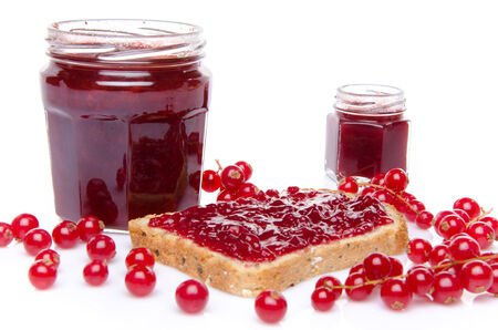 Toast with redcurrant  jam and fresh redcurrants, isolated on whiteの写真素材