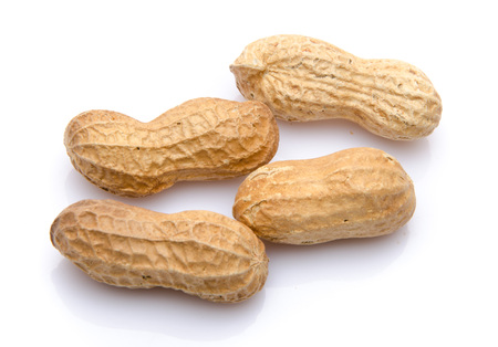 Four whole peanuts, isolated on white