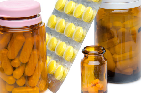 Pills in blister pack and bottles, isolated on whiteの写真素材