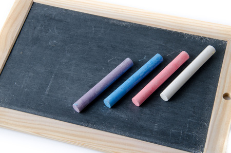 Slate with chalk sticks, isolated on whiteの写真素材