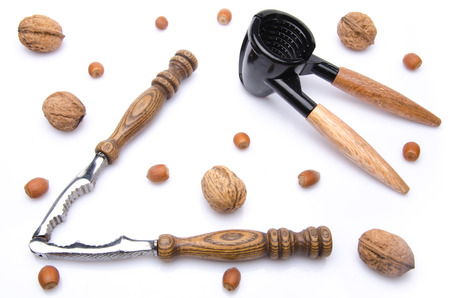 Composition with walnuts, hazelnuts and a nutcracker, isolated on white