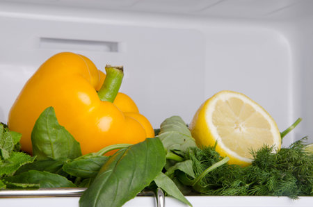 Pepper and lemon on different herbs inside a refrigeratorの写真素材