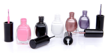 Composition with open nail polish bottles, isolated on whiteの写真素材