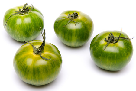 Green fresh tomatoes, isolated on whiteの写真素材
