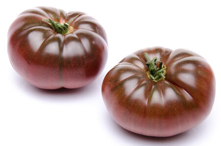 Fresh purple tomatoes, isolated on whiteの写真素材