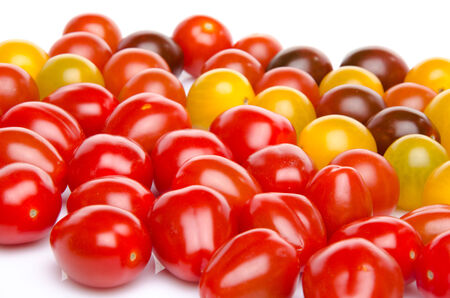 Different varieties of cherry tomatoes, isolated on whiteの写真素材