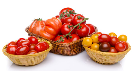 Composition of different varieties of tomatoes, isolated on whiteの写真素材