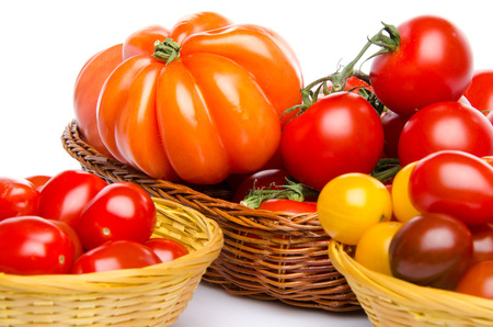 Composition of different varieties of tomatoes, isolated on whiteの写真素材