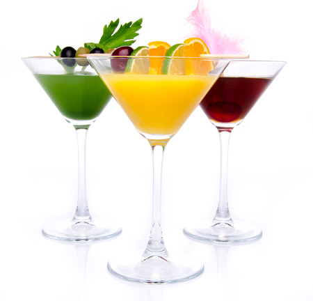 Composition with a orange, cherry and green vegetables cocktails, isolated on whiteの写真素材