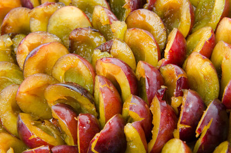Background of fresh ripe halved plumsの写真素材