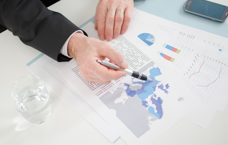 Businessman showing economic documents at the officeの写真素材