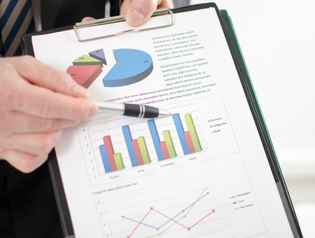 Businessman showing graphs at the officeの写真素材