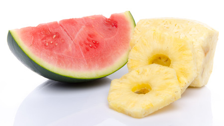 Slice of watermelon and pineapple, isolated on whiteの写真素材