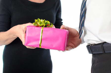 Man giving a present to a woman, isolated on whiteの写真素材