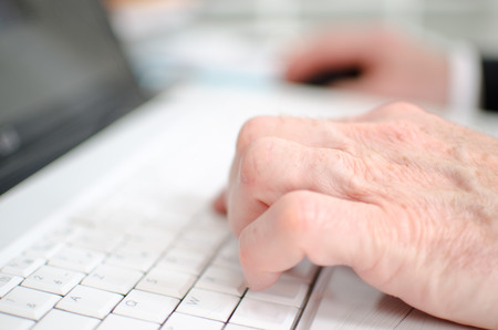 Hand typing on a keyboard, closeupの写真素材
