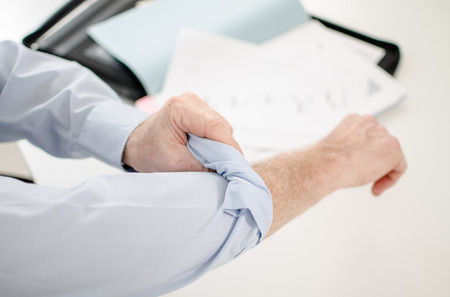 Motivated businessman rolling up his sleevesの写真素材
