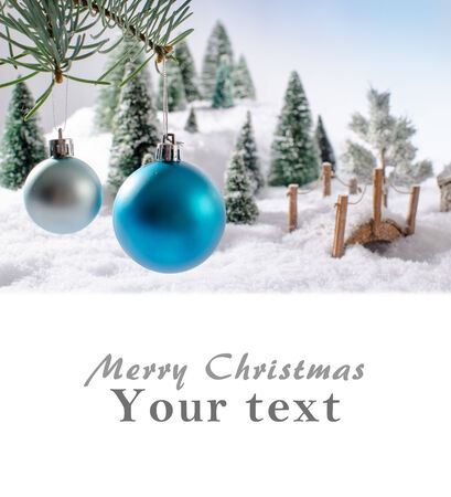Christmas card showing a winter landscape with christmas ballsの写真素材