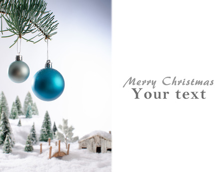 Christmas card showing a winter landscape with christmas ballsの写真素材