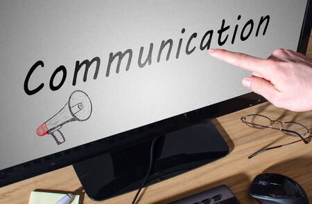 Finger showing communication on a computer screenの写真素材