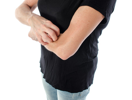Woman scratching her arm, isolated on white