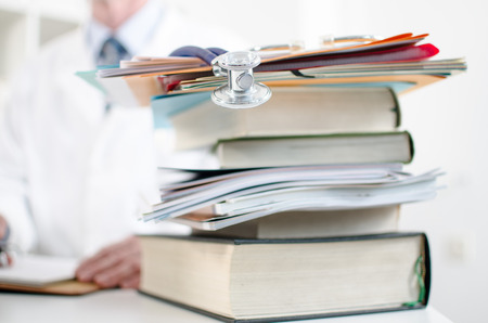 Stethoscope on a stack of medical books, closeupの写真素材