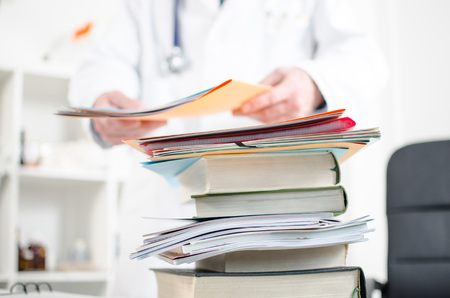 Stack of medical books on a doctor's desk
