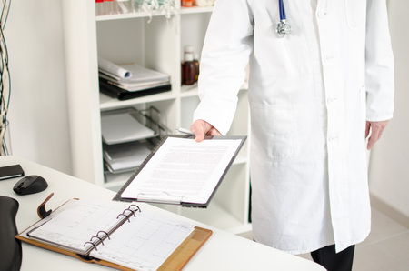 Doctor showing medical notes in his office