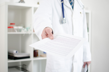 Doctor showing medical notes in his officeの写真素材