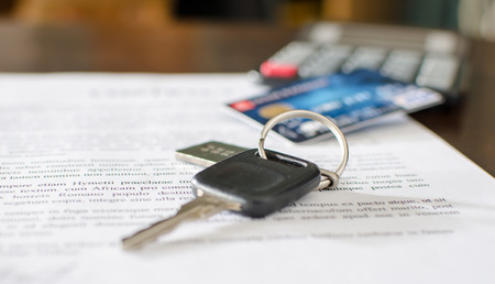 Car key, credit card on a signed sales contract, closeupの写真素材
