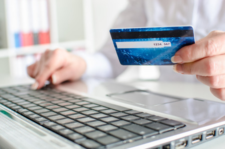 Woman making an online payment with a credit cardの写真素材