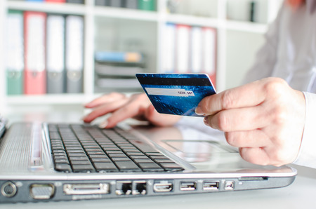 Woman making an online payment with a credit cardの写真素材