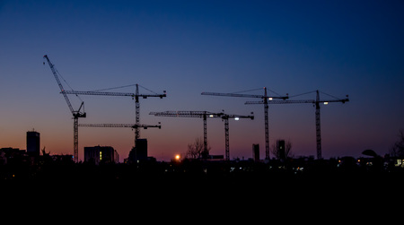 View of cranes at sunsetの写真素材