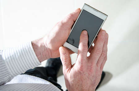 Man standing using a smartphone, top view