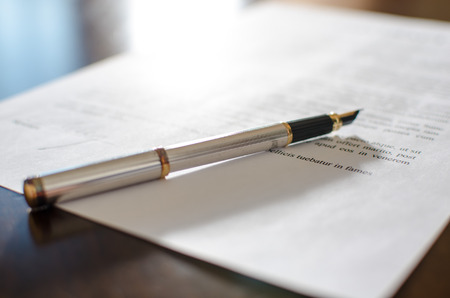 Pen placed on a signed contractの写真素材