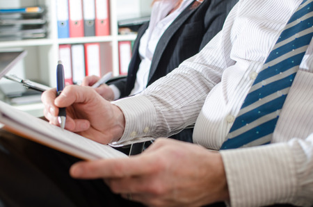 Business people taking notes during a trainingの写真素材