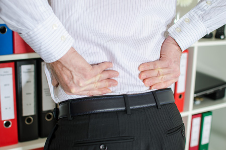 Businessman with back pain at office
