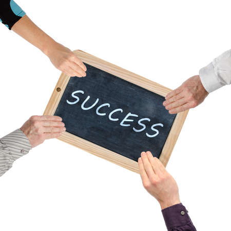 Word success on chalkboard held by handsの写真素材