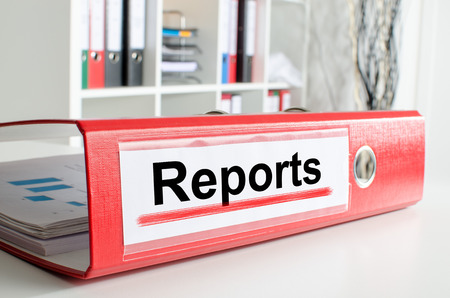 Reports wording on the back of a red binderの写真素材