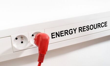 Energy resource imaged by a red plug and an electrical outletの写真素材