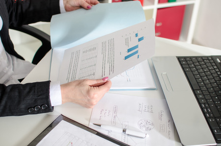 Businesswoman analyzing data at office