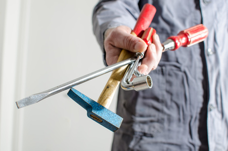 Hand holding different tools, closeupの写真素材