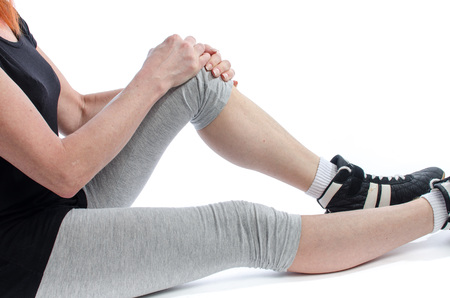 Woman holding her painful knee