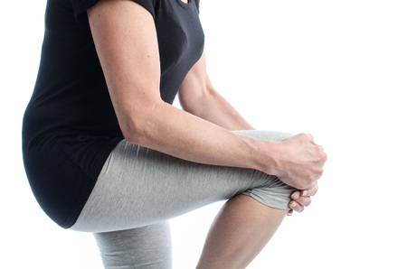 Woman holding her painful knee