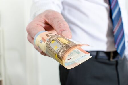 Man hand holding different euro notesの写真素材