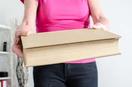 Woman hand holding a book, closeupの写真素材